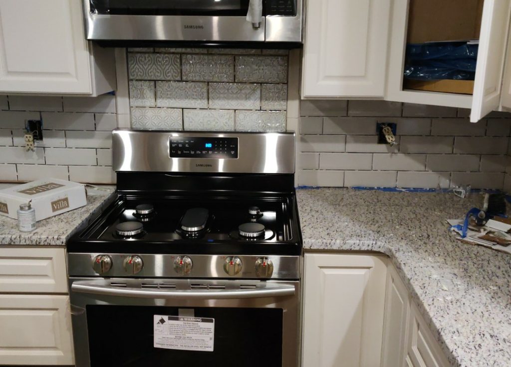 Custom Tiled backsplash installed behind range